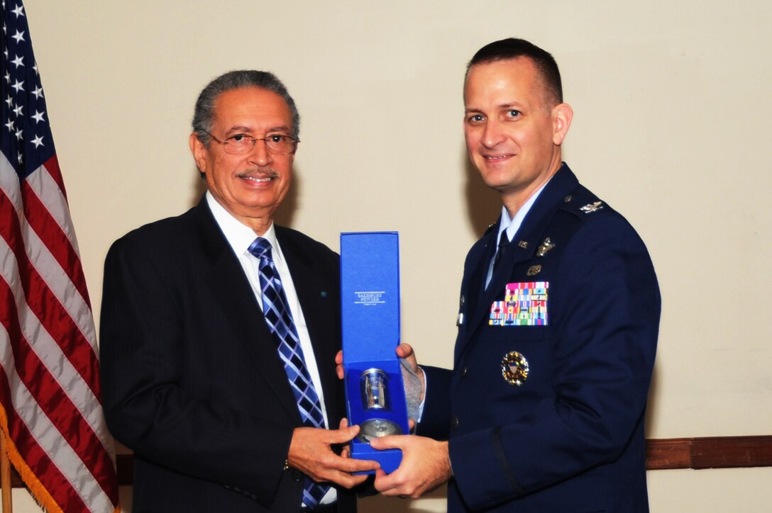 Col. Bill Knight, 11th Wing/Joint Base Andrews commander, presents a gift to Dr. Floyd J. Malveaux, M.D., Ph.D, Executive Director of Merck Childhood Asthma Network Inc., during the Martin Luther King Jr. birthday celebration at the Club at Andrews, Jan. 17, 2013. Knight presented the gift on behalf of the wing as a token of appreciation for speaking during the event. (U.S. Air Force photo/ Airman 1st Class Nesha Humes)  