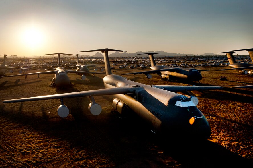 A C-5 Galaxy and other aircraft sit at sunset at the 309th Aerospace Maintenance and Regeneration Group, often called the Boneyard, at Davis-Monthan Air Force Base, Ariz., Sept. 26, 2012. The 309th AMARG is an Air Force aircraft and missile storage and maintenance facility in Tucson, Ariz. (U.S. Air Force photo/Val Gempis)