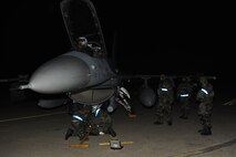 Members of the 35th Aircraft Maintenance Unit secure and inspect an F-16 Fighting Falcon that has been contaminated following a simulated attack at Kunsan Air Base, Republic of Korea, Jan. 17, 2013. The scenario is part of exercise Beverly Midnight 13-1, an exercise designed to test Kunsan Airmen’s ability to respond to various real-world scenarios. (U.S. Air Force photo by Staff Sgt. Jonathan Fowler/Released)