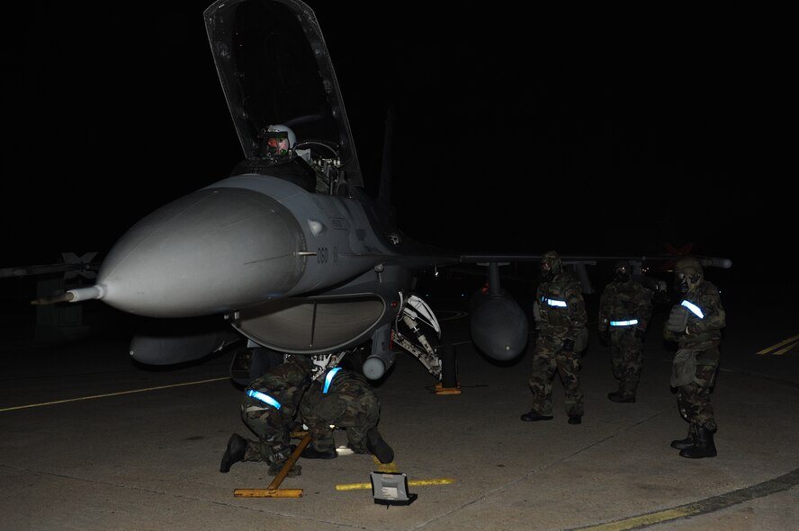 Members of the 35th Aircraft Maintenance Unit secure and inspect an F-16 Fighting Falcon that has been contaminated following a simulated attack at Kunsan Air Base, Republic of Korea, Jan. 17, 2013. The scenario is part of exercise Beverly Midnight 13-1, an exercise designed to test Kunsan Airmen’s ability to respond to various real-world scenarios. (U.S. Air Force photo by Staff Sgt. Jonathan Fowler/Released)