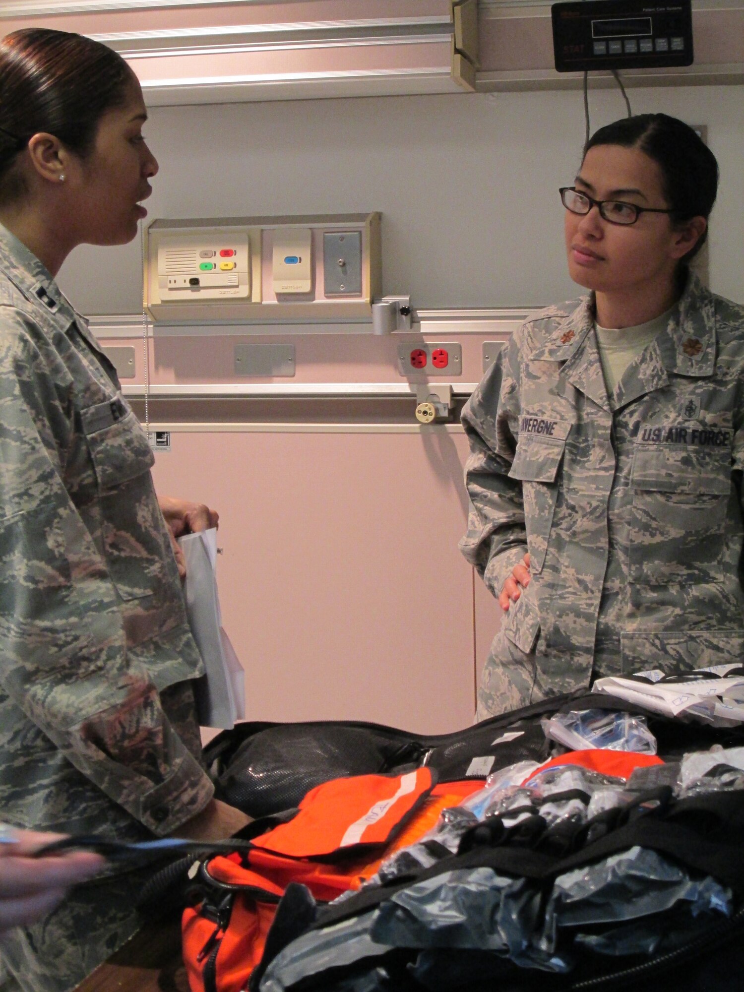 Maj. Jennifer LaVergne (right) and Capt. (Dr.) Patricia Evans discuss stocking backpacks for a medical team during a training held at Joint Base Andrews, January 10, 2013. The training is to ensure the medical team is ready to be part of the 57th Presidential Inauguration as a medical response unit. LaVergne is the Chief of medical readiness, and Evans is a physician, both are with the 79th Medical Wing. (U.S. Air Force Photo/Melanie Moore)