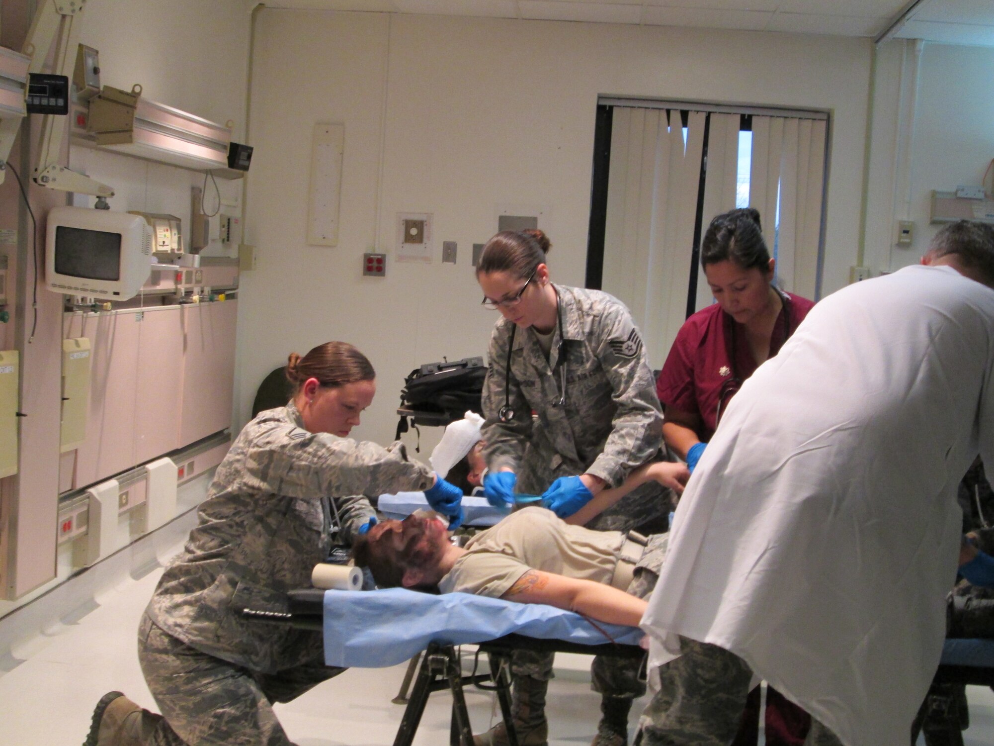 Master Sgt. Erica Jasper (left), Staff Sgt. Caitlyn Thomason and Maj. Marlo Repeta provide care for a simulated trauma victim during a training held at Joint Base Andrews January 10, 2013. The training is to ensure the team is ready to be a part of the 57th Presidential Inauguration as a medical response unit. The team is from the 79th Medical Wing. Jasper is and emergent care clinic medical technician, Thomason is a medical technician and Repeta is a nurse. (U.S. Air Force Photo/Melanie Moore)