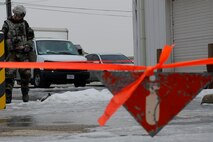 Staff Sgt. Luke Wagner, 8th Civil Engineer Squadron explosive ordnance disposal, examines unexploded ordnance during exercise Beverly Midnight 13-1 Kunsan Air Base, Republic of Korea, Jan. 14, 2013. The 8th Security Forces Squadron kept people clear of the area while Wagner properly removed the explosive. (U.S. Air Force photo by Senior Airman Marcus Morris/released)