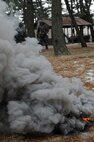 A smoke grenade goes off during exercise Beverly Midnight 13-1 at Kunsan Air Base, Republic of Korea, Jan. 17, 2013. Members of the 8th Civil Engineer Squadron explosive ordnance disposal team use smoke grenades and ground burst simulators to simulate tactical ballistic missile attacks on compounds around the base to create a more realistic training environment. (U.S. Air Force photo by Senior Airman Marcus Morris/Released)