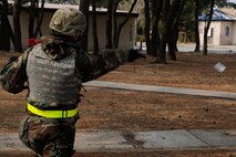 Tech. Sgt. Derek Keener, 8th Civil Engineer Squadron explosives ordnance disposal exercise evaluation team, throws a ground blast simulator (GBS) during exercise Beverly Midnight 13-1 at Kunsan Air Base, Republic of Korea, Jan. 17, 2013. The team used smoke machines and GBS to simulate a tactical ballistic missile attack on a compound. (U.S. Air Force photo by Senior Airman Marcus Morris/Released)