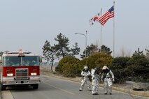 Firefighters from the 8th Civil Engineer Squadron move concertina wire during exercise Beverly Midnight 13-1 at Kunsan Air Base, Republic of Korea, Jan. 17, 2013. The team rushed in to the compound after reports of smoke in the building was heard. (U.S. Air Force photo by Senior Airman Marcus Morris/Released)