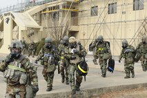 Members of the 8th Fighter Wing staff “bug-out” after a simulated power outage at their building during exercise Beverly Midnight 13-1 at Kunsan Air Base, Republic of Korea, Jan. 17, 2013. The scenario tested the member’s ability to work from a different location while completing the mission. (U.S. Air Force photo by Senior Airman Marcus Morris/Released)