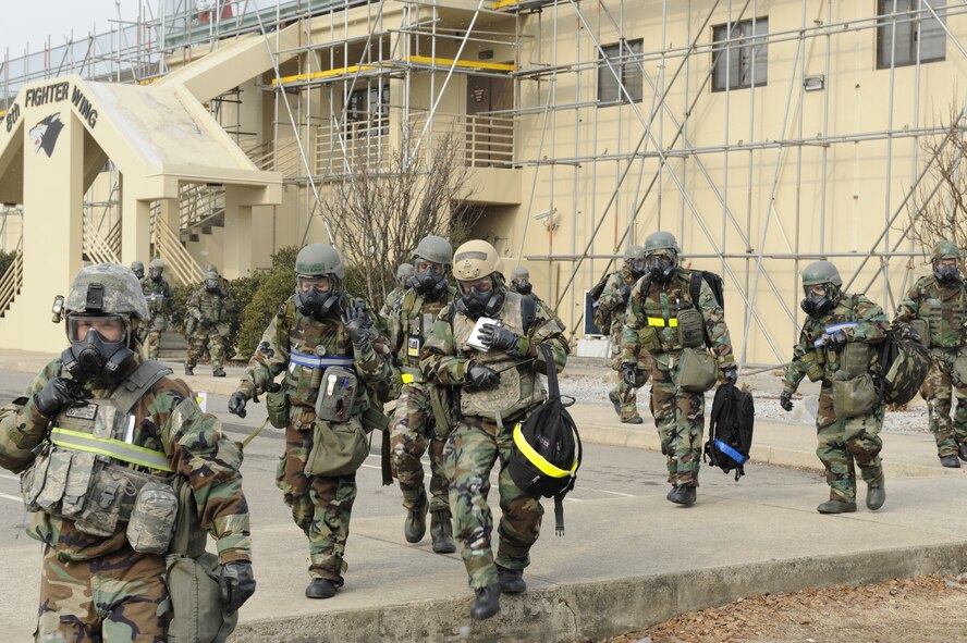 Members of the 8th Fighter Wing staff “bug-out” after a simulated power outage at their building during exercise Beverly Midnight 13-1 at Kunsan Air Base, Republic of Korea, Jan. 17, 2013. The scenario tested the member’s ability to work from a different location while completing the mission. (U.S. Air Force photo by Senior Airman Marcus Morris/Released)