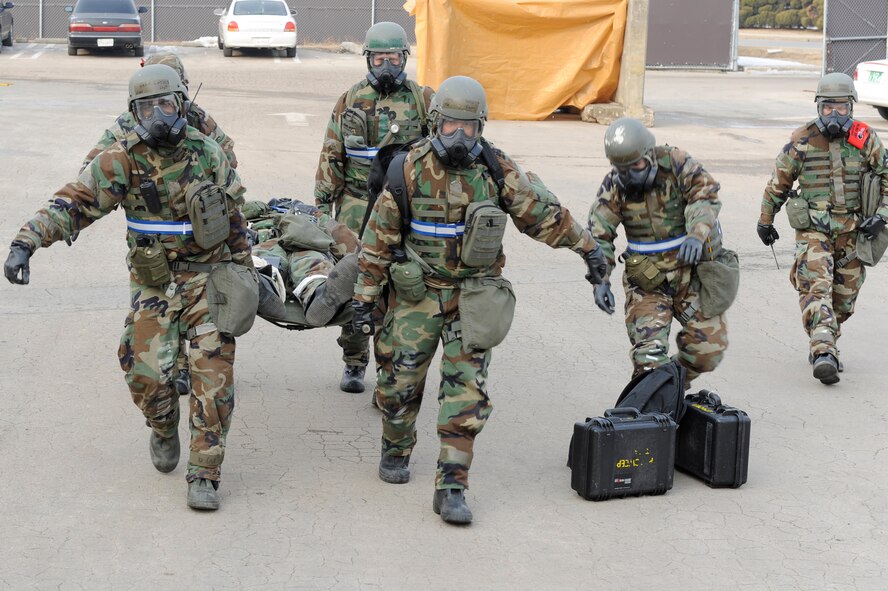 Members of the 8th Logistics Squadron carry an Airman on a stretcher as Master Sgt. Jason Novar, 8th LRS exercise evaluation team member, observes the scenario during exercise Beverly Midnight 13-1 at Kunsan Air Base, Republic of Korea, Jan. 17, 2013. The team had to use self-aid and buddy care to splint up the Airman’s legs after he fell on the ice. (U.S. Air Force photo by Senior Airman Marcus Morris/Released)