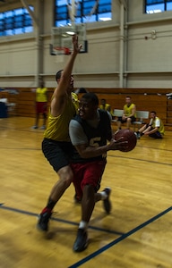 Keith Garrett, 628th Security Forces Squadron, runs the baseline as James Kirbie, 628th Logistics Readiness Squadron, attempts to defend him from driving to the basket Jan. 15, 2013, at Joint-Base Charleston, S.C.  628th LRS beat the 628th Security Forces Squadron by a score of 59 to 49 in the season opener of the 2013 intramural season. (U.S. Air Force photo/Staff Sgt. Rasheen Douglas)