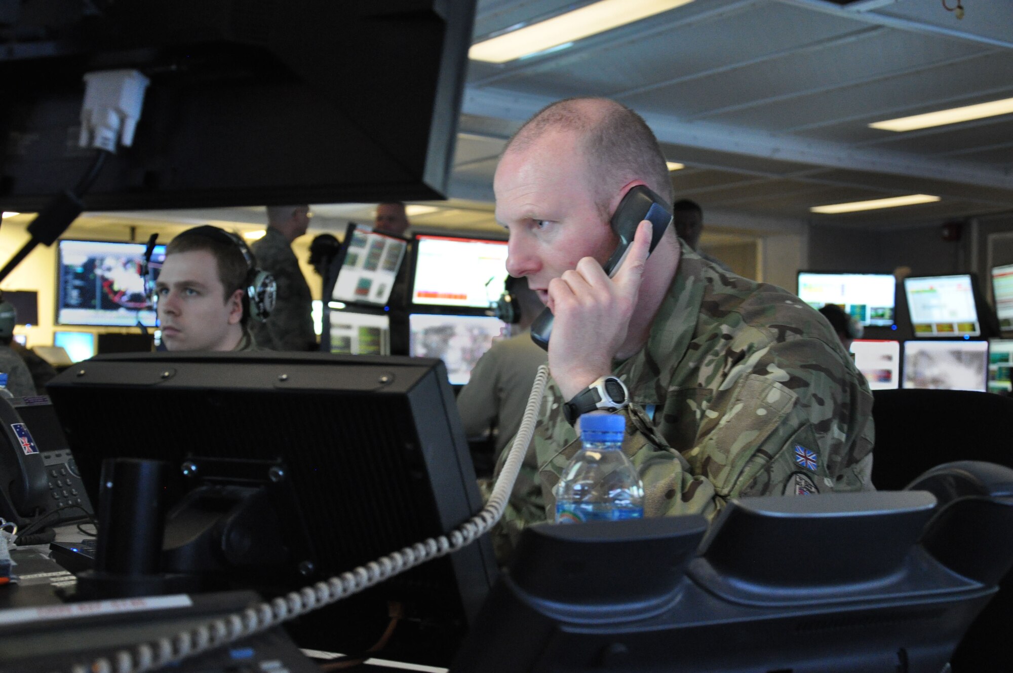 British Air Force Staff Sgt. Daz Finney, air surveillance officer, coordinates taskings, Jan. 9. The 71st Expeditionary Air Control Squadron monitors airspace throughout the coalition area of responsibility in Southwest Asia and serve as a failsafe measure for other forward air monitoring services. The outgoing rotation is the final group of air surveillance professionals from Aviano Air Base, Italy, and will return home soon. (U.S. Air Force photo/Master Sgt. Christian Michael)
