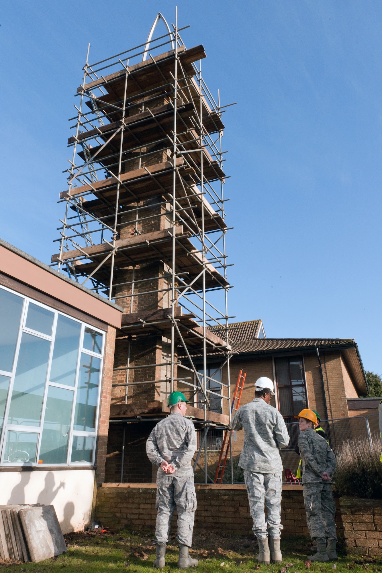 RAF CROUGHTON, United Kingdom - (left to right) Chap. (Maj.) Peter Fischer, 501st CSW wing chaplain, and Chap. (Maj.) Earnest Beeman, 422nd Air Base Group chaplain, give (Col.) Cherri Wheeler, U.S. Air Forces in Europe command chaplain, a tour of the construction at the RAF Croughton Chapel Jan. 9. The RAF Croughton Chapel was able to save the bell tower as part of the renovation. The U.S. Air Forces in Europe command chaplain visited almost every installation within the 501st Combat Support Wing during the week of Jan. 7 as part of the National Prayer Breakfast and site visits. (U.S. Air Force photo by Staff Sgt. Brian Stives)