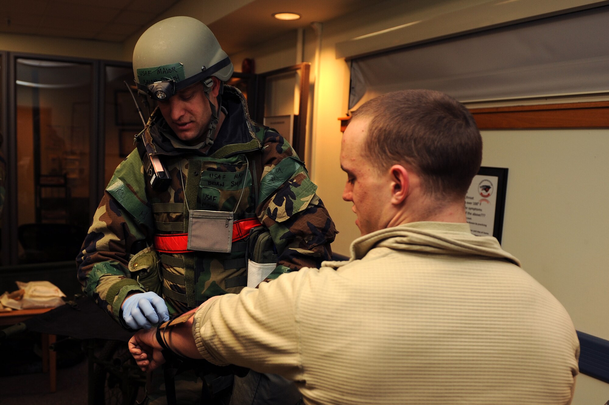 Maj. Brian Smith, 8th Medical Operations Squadron, inspects the arm of Airman 1st Class William Clarke, 8th Fighter Wing role player, during Exercise Beverly Midnight 13-1 at Kunsan Air Base, Republic of Korea, Jan. 17, 2013. Smith was being assessed on the procedures he used to identify and treat Clarke’s injury. (U.S. Air Force photo by Staff Sgt. Jonathan Fowler/Released)