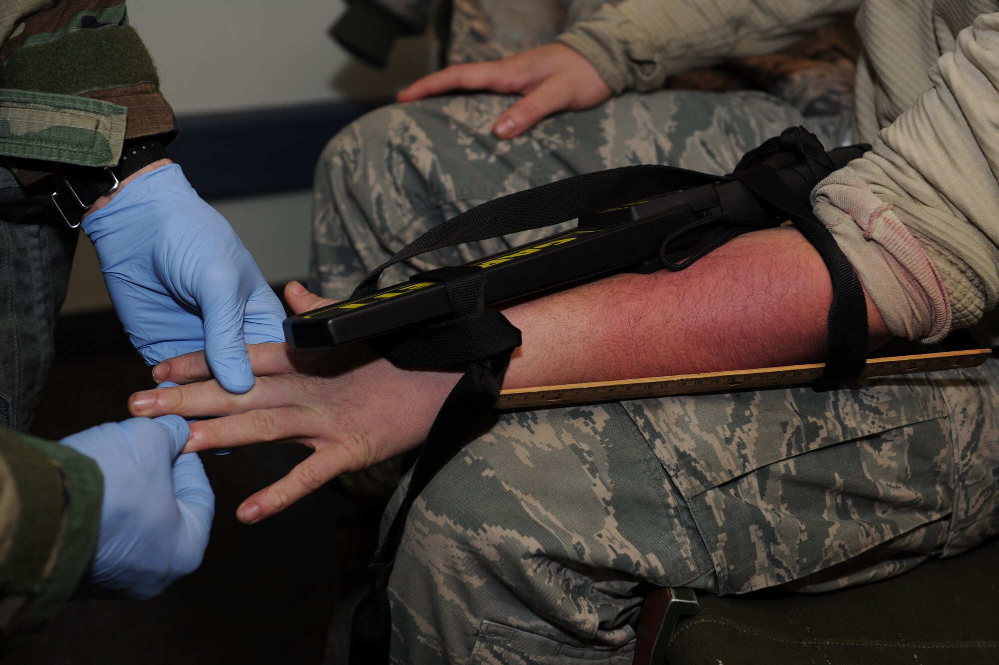 Maj. Brian Smith, 8th Medical Operations Squadron, checks the hand of Airman 1st Class William Clarke, 8th Fighter Wing role player, during Exercise Beverly Midnight 13-1 at Kunsan Air Base, Republic of Korea, Jan. 17, 2013. Clarke received a simulated broken arm following an exercise scenario; this situation was designed to assess Smith’s ability to identify and treat the injury. (U.S. Air Force photo by Staff Sgt. Jonathan Fowler/Released)