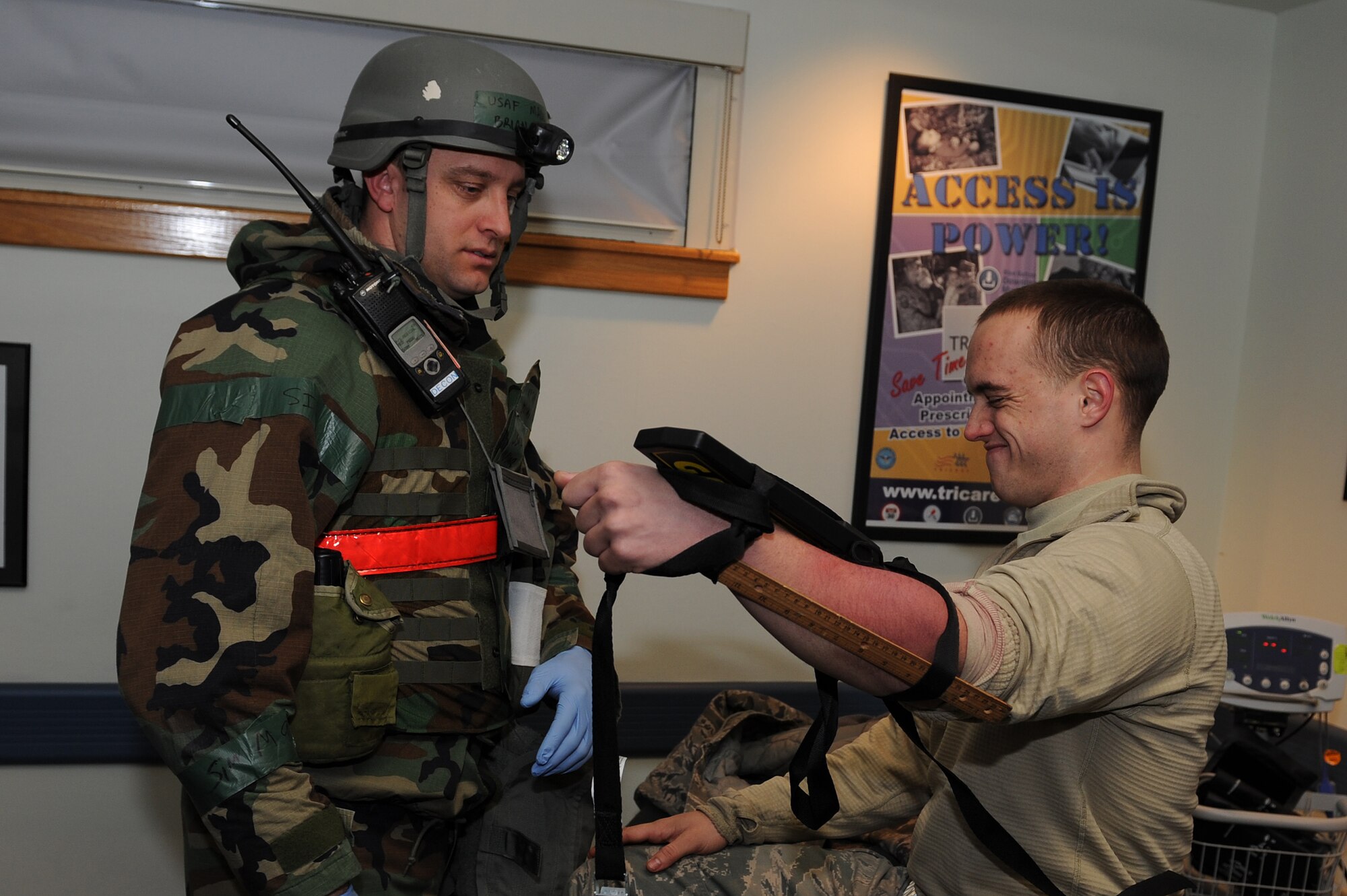 Maj. Brian Smith, 8th Medical Operations Squadron, inspects the arm of Airman 1st Class William Clarke, 8th Fighter Wing role player, during Exercise Beverly Midnight 13-1 at Kunsan Air Base, Republic of Korea, Jan. 17, 2013. Clarke suffered from a simulated broken arm and Smith was assessed on his ability to identify and treat the injury. (U.S. Air Force photo by Staff Sgt. Jonathan Fowler/Released)