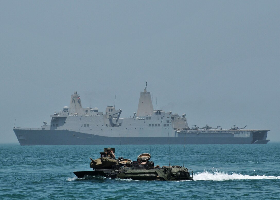 Marines pilot an amphibious assault vehicle with the amphibious transport dock ship USS New York in the background while operating in the Arabian Sea. USS New York, with the embarked 24th Marine Expeditionary Unit, was part of the Iwo Jima Amphibious Ready Group. U.S. Navy photo by Petty Officer 2nd Class Zane Ecklund