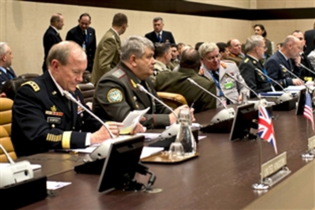 U.S. Army Gen. Martin E. Dempsey, chairman of the Joint Chiefs of Staff, reviews material while attending the NATO Chiefs of Defense conference in Brussels, Jan. 17, 2013.