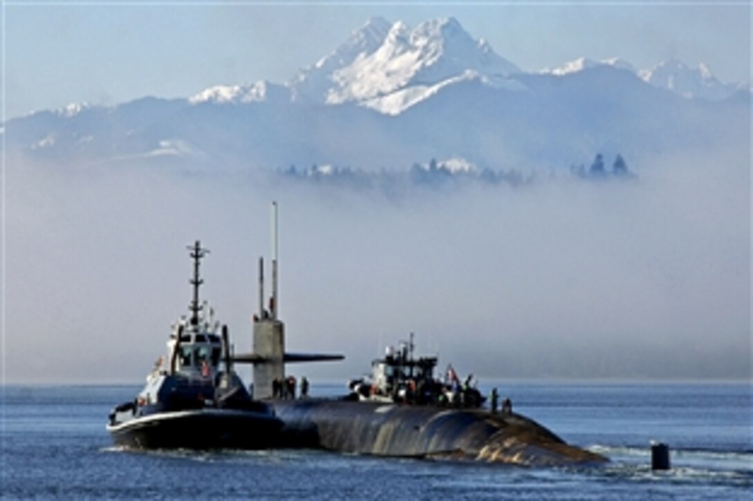 The ballistic missile submarine USS Henry M. Jackson transits past the Olympic Mountains as it prepares to conduct sea trials in Bangor, Wash., Jan. 16, 2013.