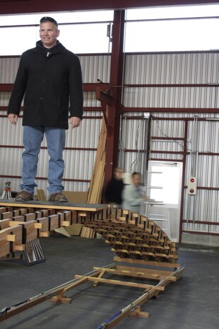 Sgt. Maj. Steven Brown, Marine Corps Air Station Iwakuni sergeant major, stands on the
finished replica of a Kintai Bridge arch at Sekido Storage Warehouse, Dec. 7, 2012. Patrons
learned about the architecture of the bridge and applied the knowledge toward working
together and completing the replica.