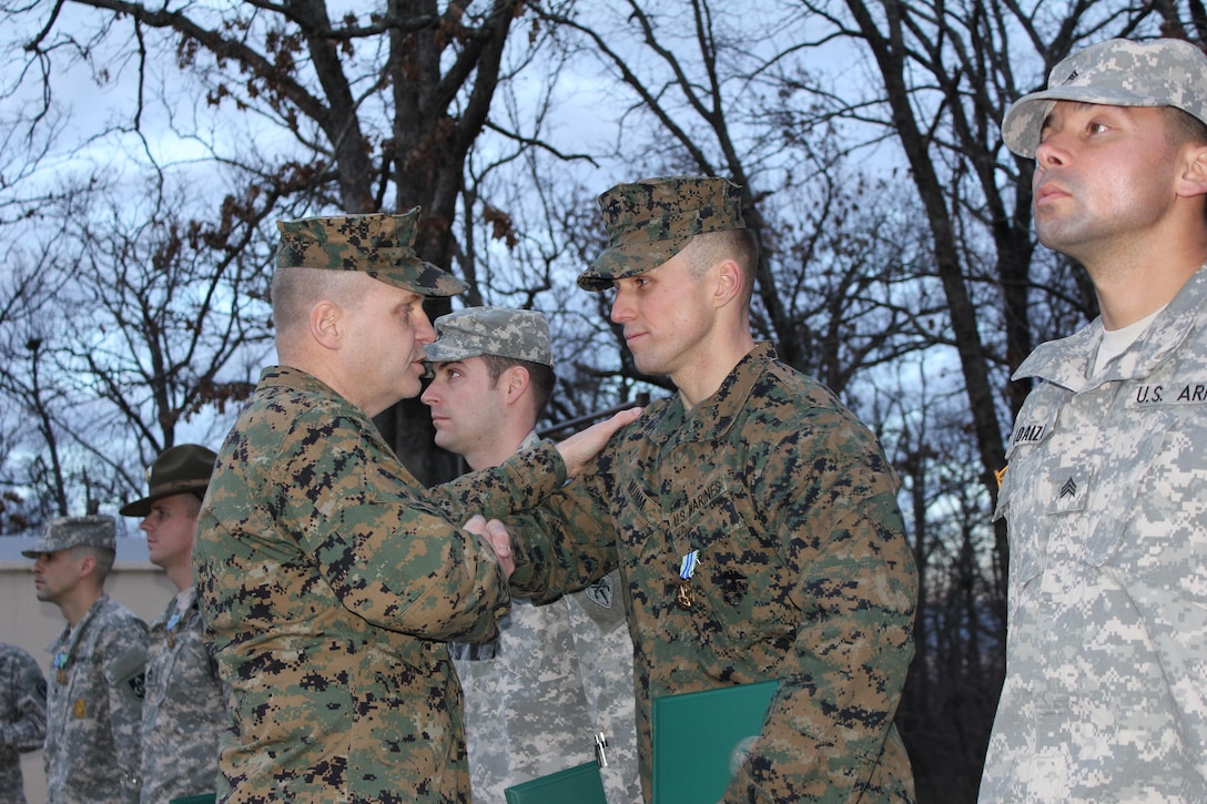 Sgt Mumm is presented with an award for winning the Joint Service portion of the Best Warrior Competition for the third quarter. The presentation was held at Training Area 247 on January 8, 2013.