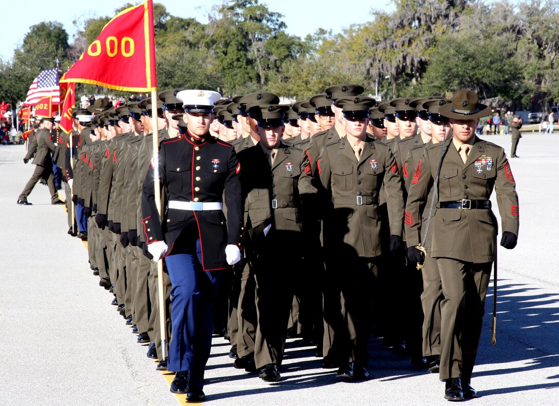 Private First Class Jacob Watson, of Phenix City, Ala., and company honor graduate for Company D, carries his platoon’s guidon while marching in his dress blues during the past and review portion of graduation aboard Parris Island, S.C., Jan. 18, 2013.  Upon graduation, Watson will spend time with his family while on leave, before heading to Camp Geiger, N.C., where he will undergo Marine Combat Training before reporting to his Military Occupational Specialty school. (U.S. Marine Corps photo by Capt. Barry Morris)