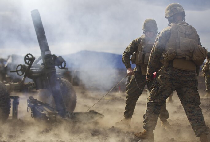 Cpl. Michael Oberley, 1st Battalion, 12th Marine Regiment section chief and native of Greeley, Colo., and Cpl. Kyle Beagle, 1st Bn., 12th Marines mortar gunner and native of Deland, Fla., fire a round from a 120-mm mortar system during a training session for Operation Spartan Fury, Dec. 2.