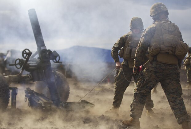 Cpl. Michael Oberley, 1st Battalion, 12th Marine Regiment section chief and native of Greeley, Colo., and Cpl. Kyle Beagle, 1st Bn., 12th Marines mortar gunner and native of Deland, Fla., fire a round from a 120-mm mortar system during a training session for Operation Spartan Fury, Dec. 2.