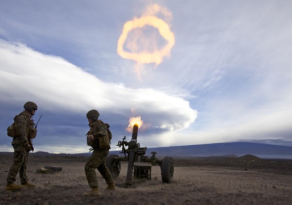 Cpl. Michael Oberley, 1st Battalion, 12th Marine Regiment section chief and native of Greeley, Colo., and Cpl. Kyle Beagle, 1st Bn., 12th Marines mortar gunner and native of Deland, Fla., fire a round from a 120-mm mortar system creating a fire ring during a training session for Operation Spartan Fury, Dec. 2.