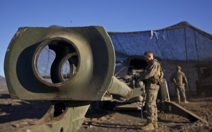 POHAKULOA TRAINING AREA, Hawaii - Cpl. Michael Oberley, 1st Battalion, 12th Marine Regiment section chief and native of Greeley, Colo., inspects the mechanics of a M777A2 155 mm light howitzer before a firing mission during Operation Spartan Fury, Dec. 4. During the following days, the Marines and sailors of 1st Bn., 12th Marines updated their proficiency in mortar and howitzer shooting drills and applied those skills and techniques to a mock battle scenario. (Official U.S. Marine Corps photo by Cpl. James A. Sauter)