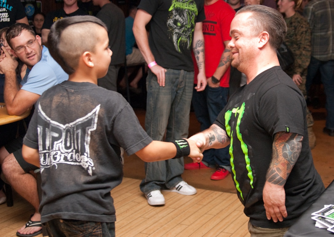 MARINE CORPS BASE HAWAII - Justin Clay, 8, shakes hands with Jason “Wee Man” Acuna at Kahuna’s Bar and Grill, Jan. 11, 2013. Acuna signed autographs and posed for photos with Kahuna’s patrons as part of the “Wee Man Salutes the Service Tour.” Acuna, known for his role on MTV’s “Jackass,” recently starred in the 2012 movie “Elf Man.” (Official U.S. Marine Corps photo by Kristen Wong)