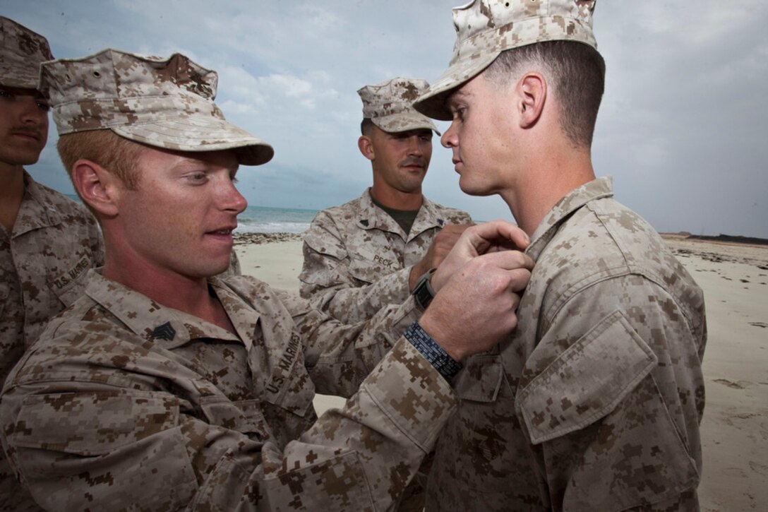 Lance Cpl. Raymond J. Riis, Lima Company, Battalion Landing Team 3/5, 15th Marine Expeditionary Unit, receives his new rank of corporal during a promotion ceremony in the U.S. 5th Fleet area of responsibility, Dec. 14, 2012. The 15th MEU is deployed as part of the Peleliu Amphibious Ready Group as a U.S. Central Command theater reserve force, providing support for maritime security operations and theater security cooperation efforts in the U.S. 5th Fleet area of responsibility. (U.S. Marine Corps photo by Cpl. Bobby J. Gonzalez)