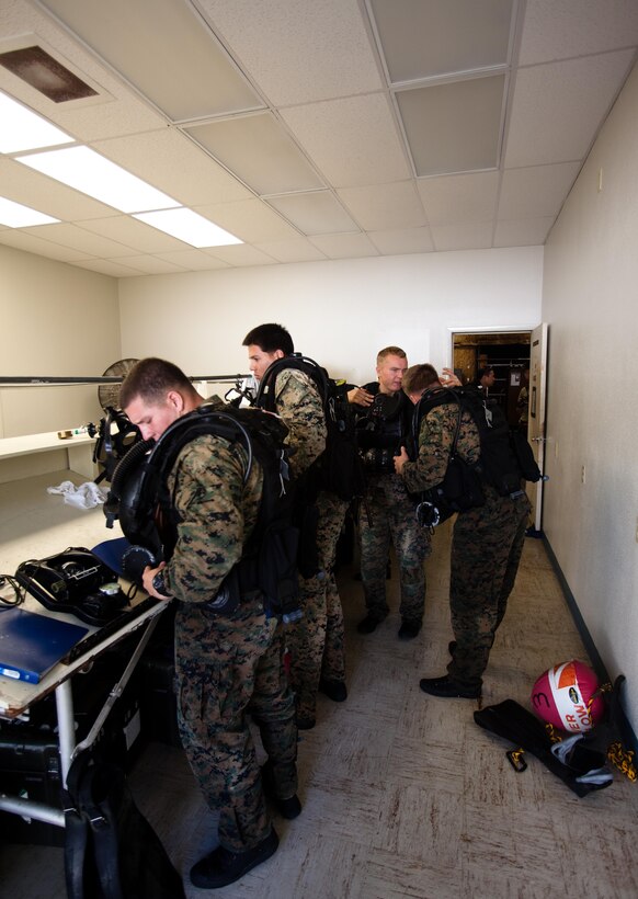 MARINE CORPS BASE HAWAII - Marines with Bravo Company, 3rd Reconnaissance Battalion, don their amphibious diving gear before conducting a dive training evolution with Republic of Singapore sailors at a water ramp at the 4th Force Reconnaissance Company compound on Marine Corps Base Hawaii, Jan. 9. (Official U.S. Marine Corps photo by Cpl. James A. Sauter)