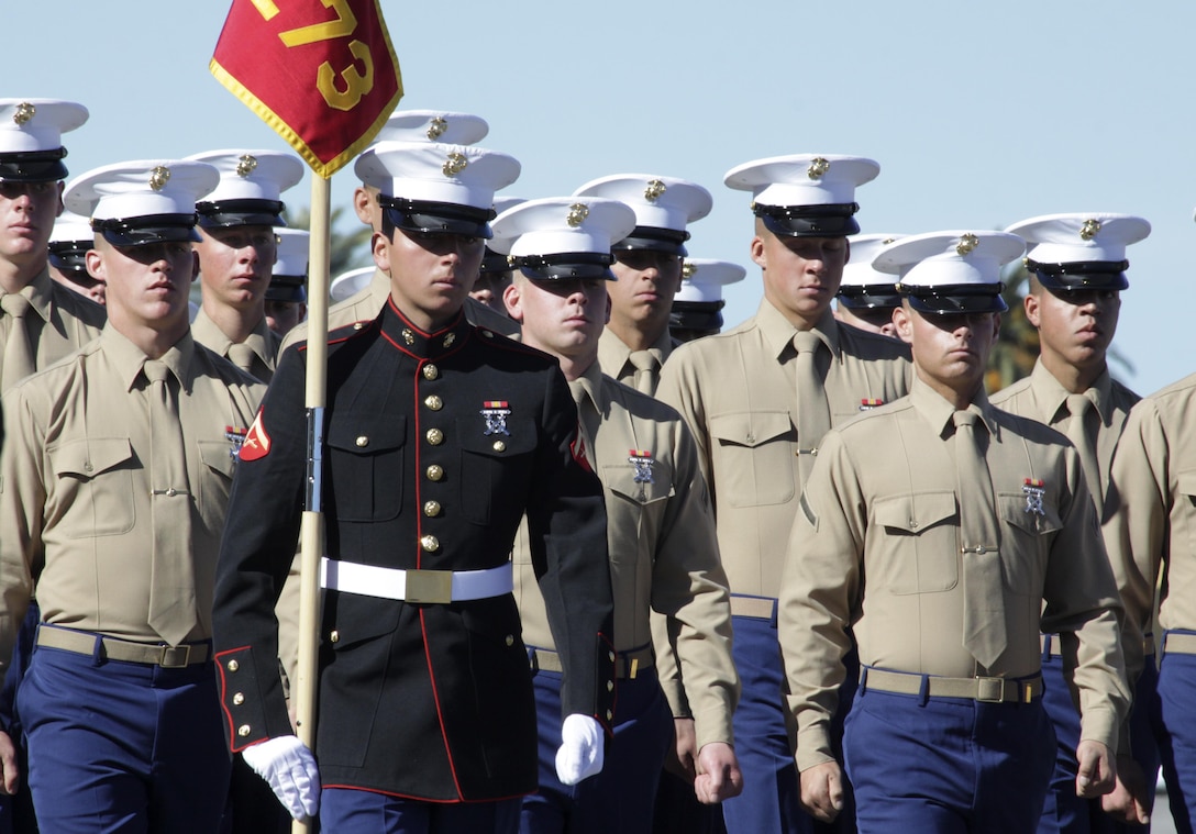 Lance Cpl. Adam Cardenas, honor graduate for Mike Company, and a Redlands, Calif., native, marches with his platoon's guidon during graduation aboard Marine Corps Recruit Depot, San Diego, Jan., 17. Cardenas said all the blood, sweat and tears during recruit training were worth it after finishing the reaper. The reaper is a 12-mile hike marking the end of recruit training and where recruits earn the title “Marine.”