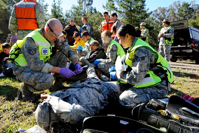 VANDENBERG AIR FORCE BASE, Calif. - Base medical teams provide first aid and assistance to an exercise 'injured' Team V member during an active shooter scenario here, Thursday, Jan. 18, 2013. The exercise was Team V's final emergency management scenario to sharpen their crisis response skills before the installation's upcoming Unit Compliance Inspection. (U.S. Air Force photo/Staff Sgt. Levi Riendeau)
