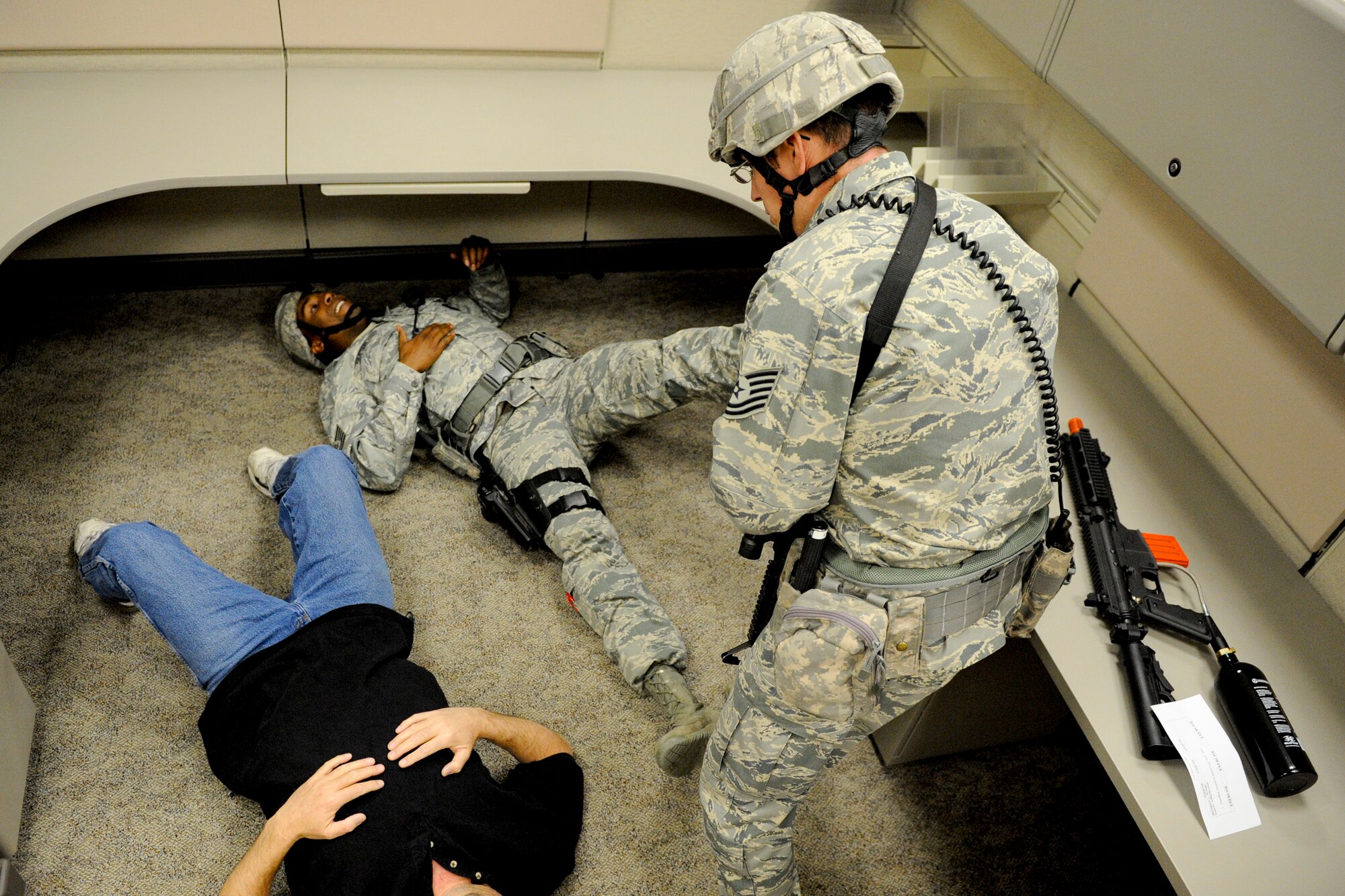 VANDENBERG AIR FORCE BASE, Calif. -- A 30th Security Forces Squadron member provides buddy care to a fellow defender after taking down a simulated 'active shooter' inside a facility here, Thursday, Jan. 18, 2013. The exercise was Team V's final emergency management scenario to sharpen their crisis response skills before the installation's upcoming Unit Compliance Inspection. (U.S. Air Force photo/Staff Sgt. Levi Riendeau)
