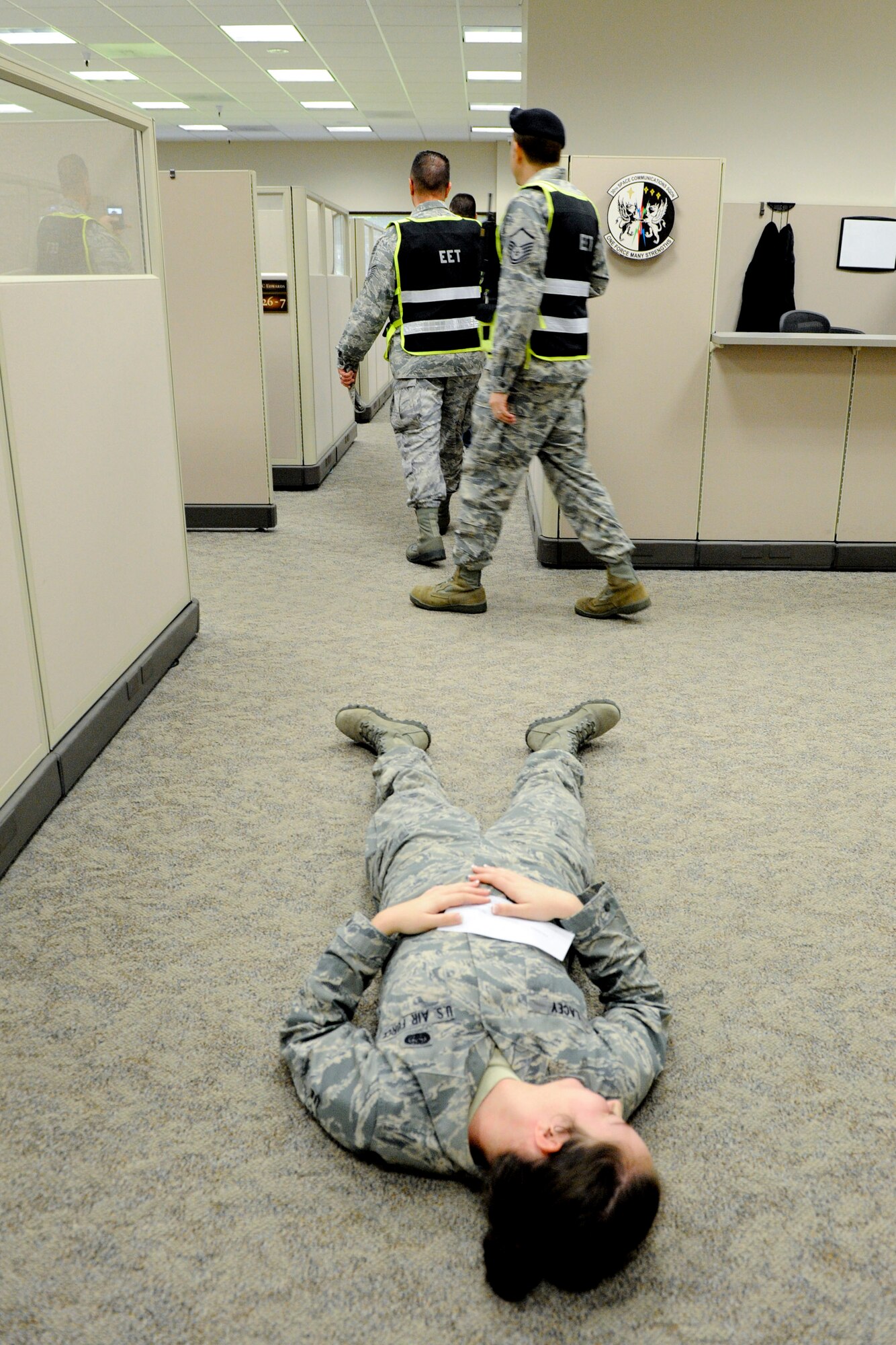 VANDENBERG AIR FORCE BASE, Calif. -- Exercise Evaluation Team members survey the scene and 'casualties' during an active shooter exercise inside a facility here, Thursday, Jan. 18, 2013. The exercise was Team V's final emergency management scenario to sharpen their crisis response skills before the installation's upcoming Unit Compliance Inspection. (U.S. Air Force photo/Staff Sgt. Levi Riendeau)
