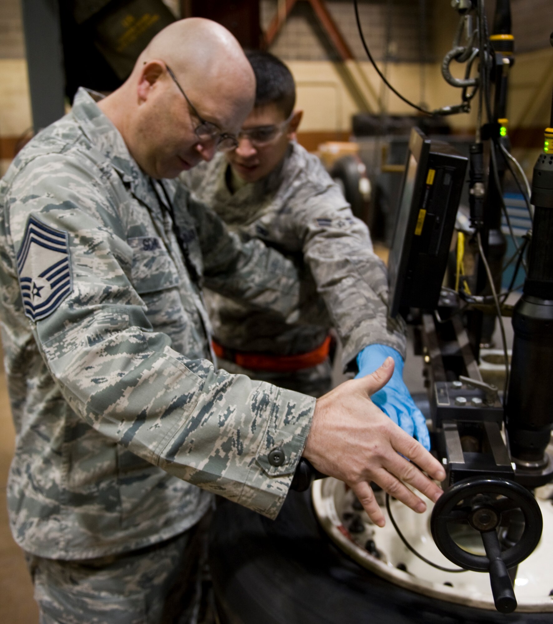 Airman 1st Class Justin Davis, 7th Equipment Maintenance Squadron, shows Chief Master Sgt. Thomas Schwenk, Air Combat Command Inspector General team chief, the process they use to repair tires for B-1 and C-130 aircraft Jan. 15 during the 7th Bomb Wing’s Consolidated Unit Inspection. During the inspection, more than 160 inspectors closely examined how well the 7th BW’s programs, plans and procedures follow Air Force Instructions and Department of Defense Directives. The inspection results are graded on the Air Force five-tier grading scale: Outstanding, Excellent, Satisfactory, Marginal and Unsatisfactory. (U.S. Air Force photo by Airman 1st Class Peter Thompson/ Released)