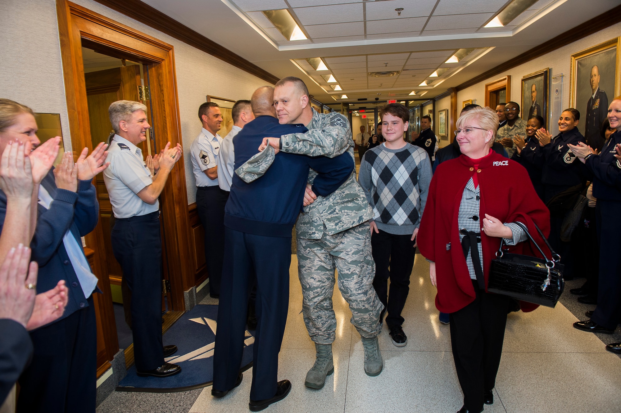 Chief Master Sgt. of the Air Force James Roy hugs Air Force Vice Chief of Staff Gen. Larry Spencer, while Roy and his family depart the Pentagon, Jan. 17. 2013, on his last day in the office prior to his retirement and transition ceremony on Jan. 24.  Roy is the 16th chief master sergeant of the Air Force. (U.S. Air Force photo/Jim Varhegyi)