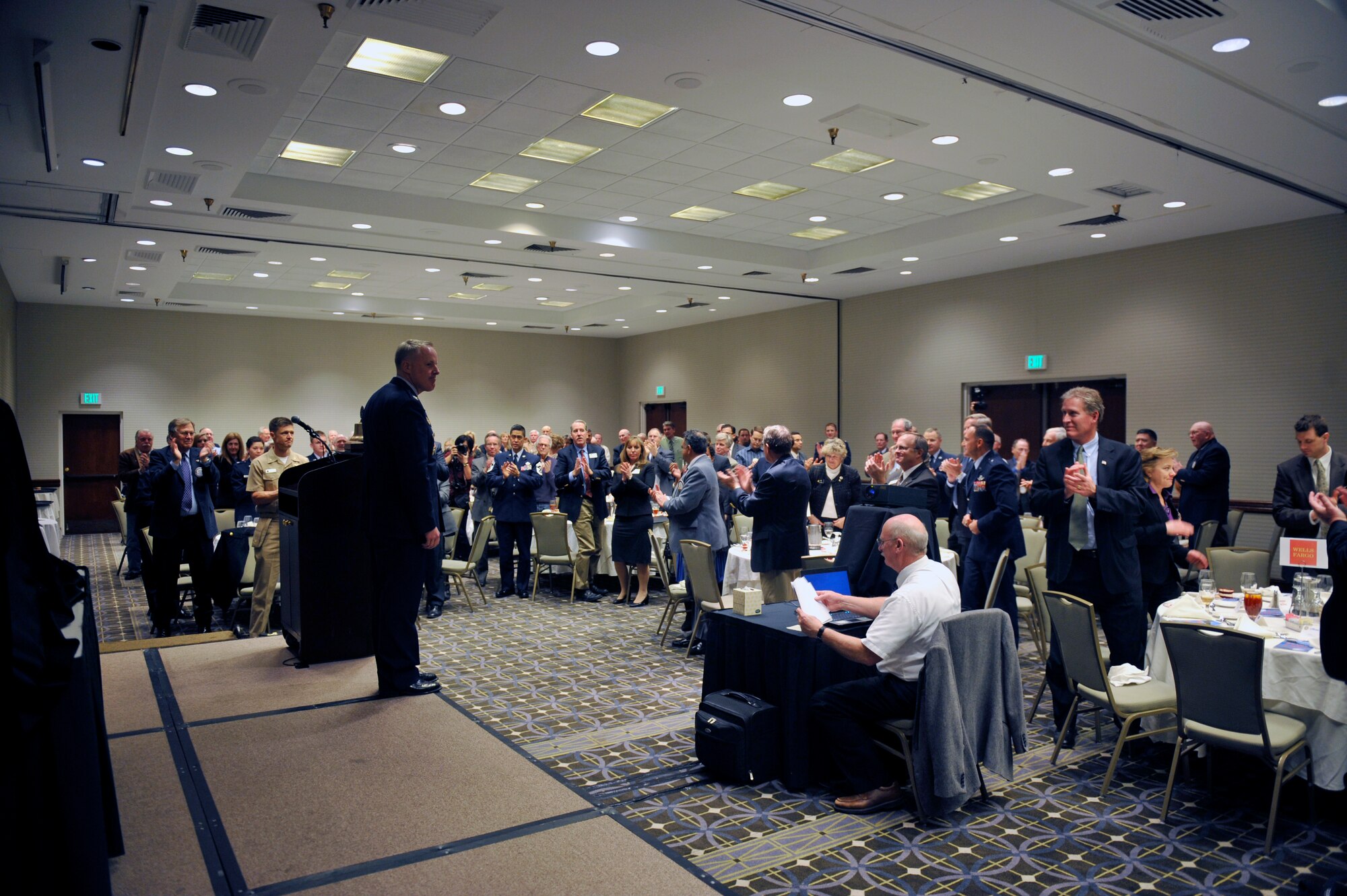 Col. Daniel Dant, 460th Space Wing commander, receives a standing ovation from audience members during a State of the Base address Jan. 16, 2013, at the Double Tree Hotel in Aurora, Colo. Dant spoke about the positive economic impact the base has on the Aurora and regional communities. (U.S. Air Force photo by Airman 1st Class Riley Johnson/Released)