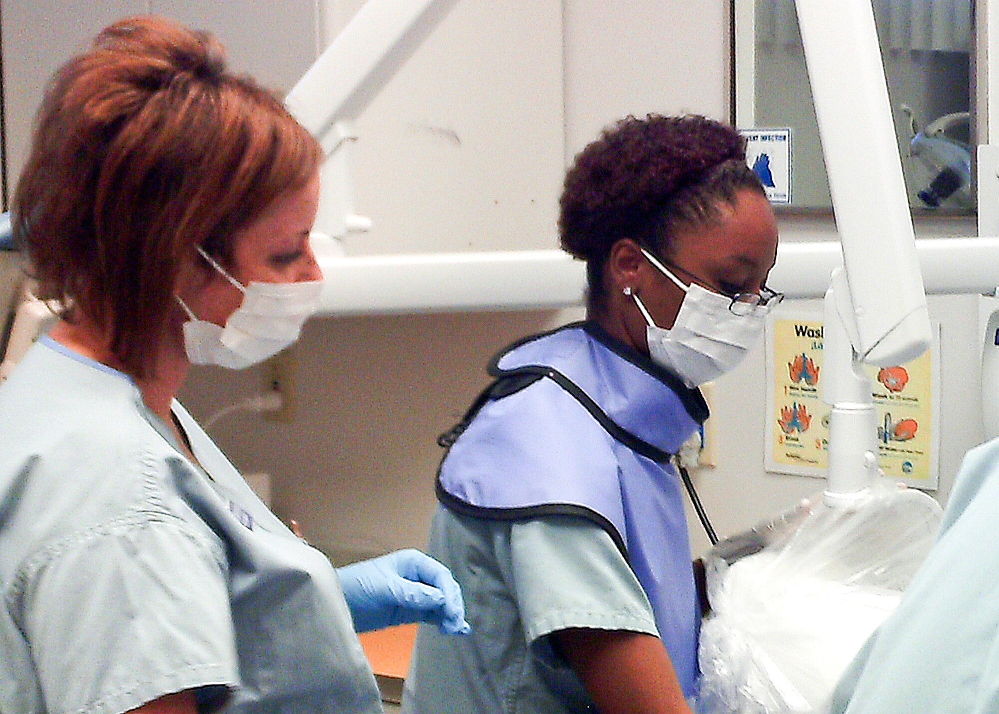 Tech. Sgt. Shanna Binion and Senior Airman Whittney Ellington, 90th Medical Group dental technicians, work to create dental records to help the Wyoming State Crime Lab positively identify human remains Sept. of 2010 in the F. E. Warren Dental Clinic. (Courtesy photo)