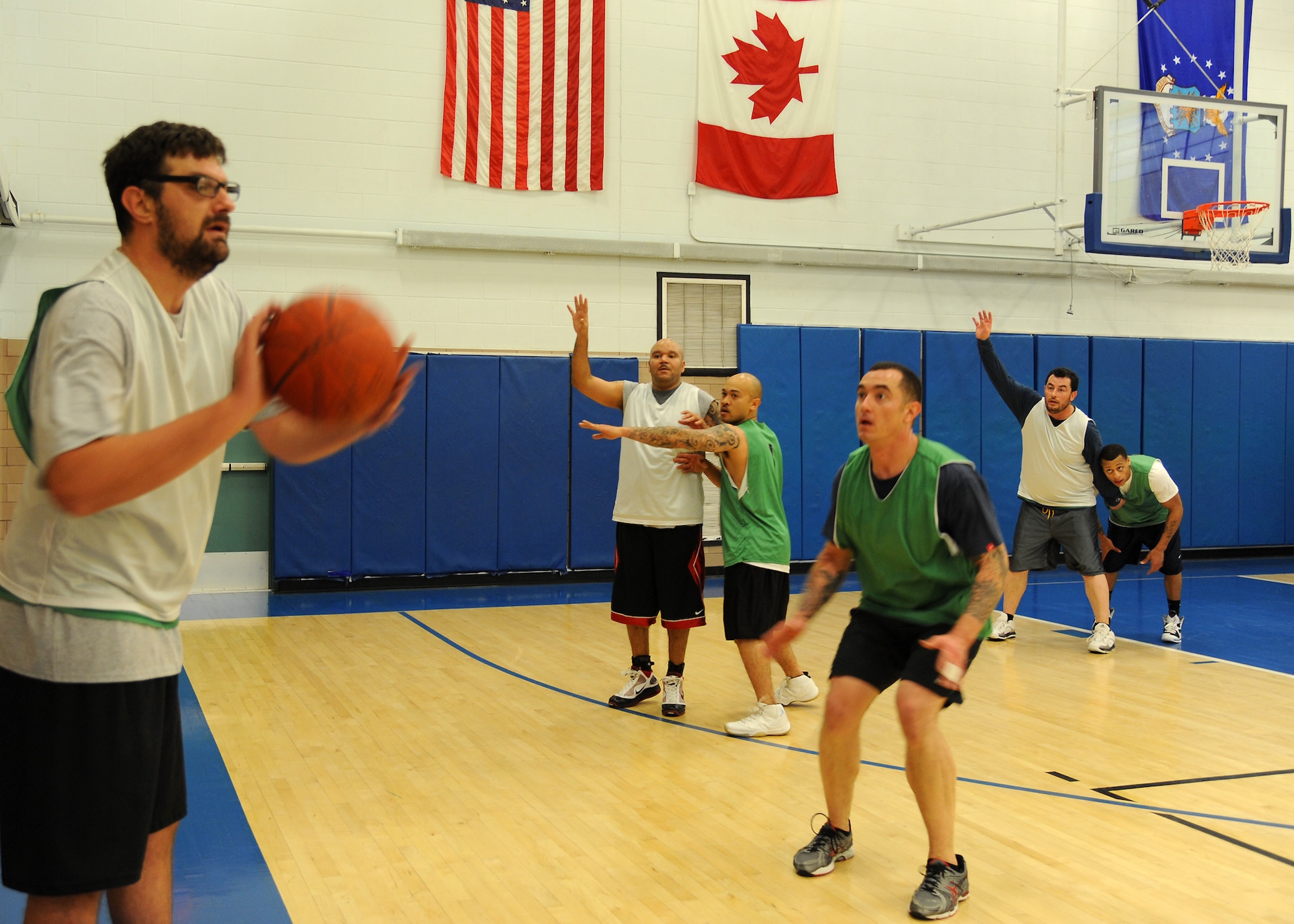 A 69th Reconnaissance Group team member looks for an opening to pass during the over-30 basketball championship game Jan. 9, 2013, at the Fitness Center on Grand Forks Air Force Base, N.D. The 69th RG defeated the 319th Security Forces Squadron 46-40 to earn the right to be called champions. (U.S. Air Force photo/Airman 1st Class Xavier Navarro)