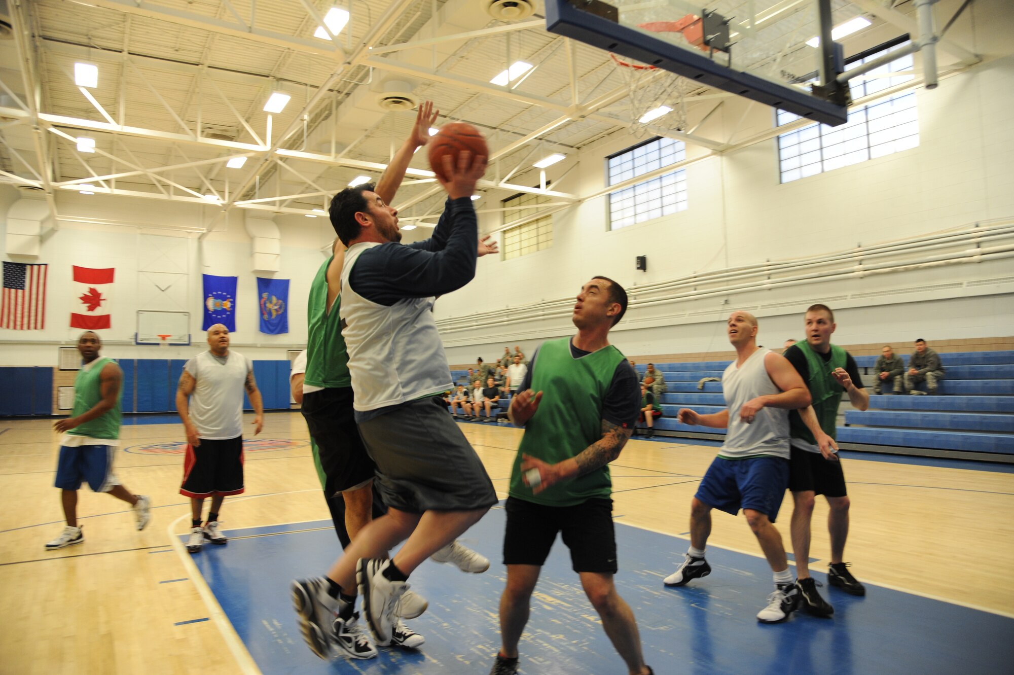 A team member of the 69th Reconnaissance Group rises above his defender for a jump shot during the over-30 basketball championship game Jan. 9, 2013, at the Fitness Center on Grand Forks Air Force Base, N.D. The 69th RG defeated the 319th Security Forces Squadron 46-40 in the championship game. (U.S. Air Force photo/Airman 1st Class Xavier Navarro)