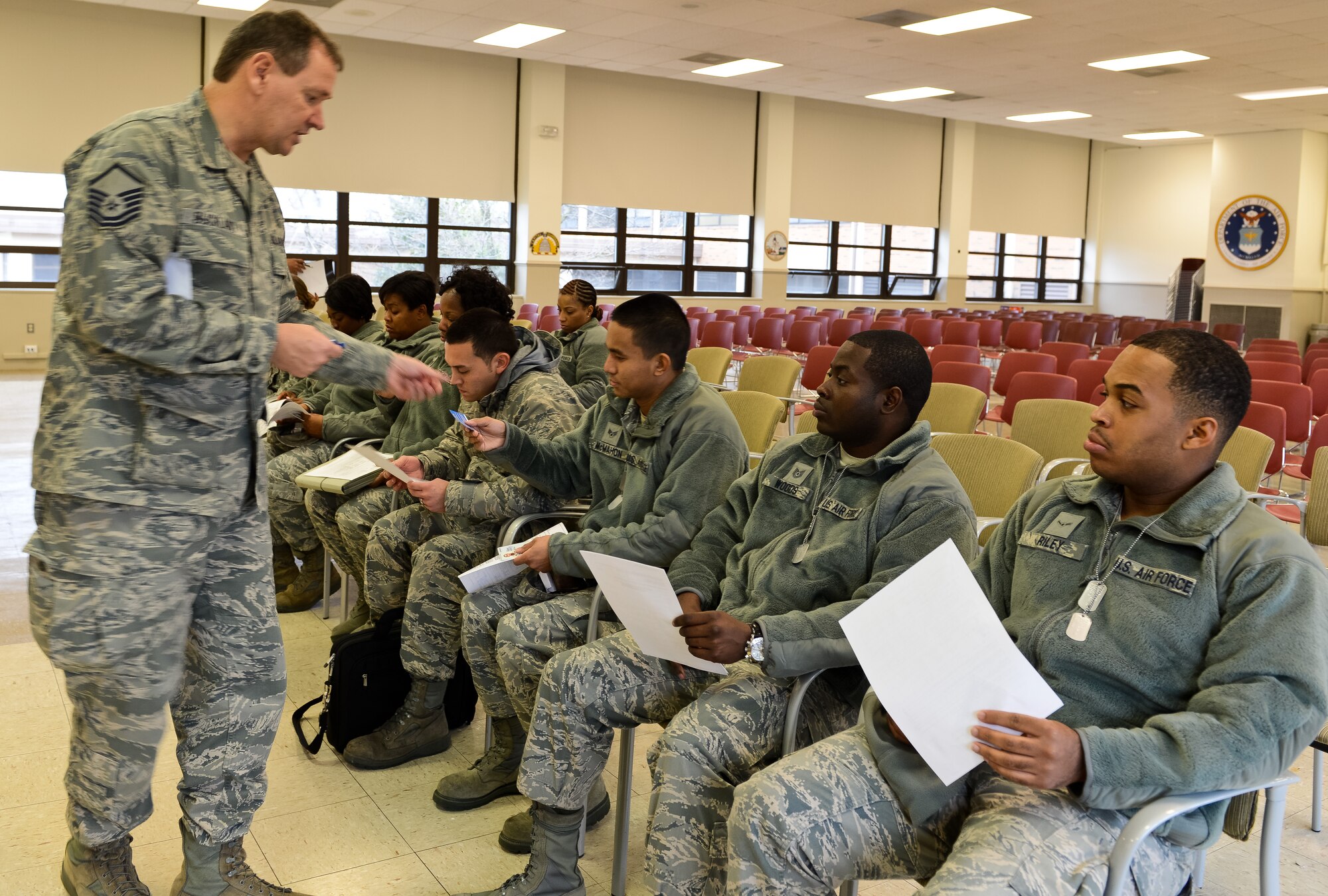 Air National Guard Master Sgt. Gareth Buckland from the 113 Wing Public Affairs, Joint Base Andrews, Md., hands out media cards to members of the Joint STARS 116th Force Support Squadron (FSS) from Robins Air Force Base, Ga., during in-processing for the 57th Presidential Inauguration at Joint Base Andrews, Jan. 17, 2013.  The Georgia Guardsman traveled to the National Capital Region with their field kitchen in tow to provide food service to troops supporting the events surrounding the inauguration.  (National Guard photo by Master Sgt. Roger Parsons/Released)