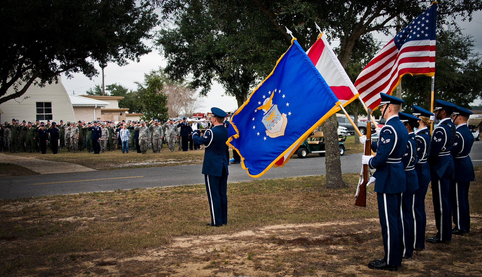 Members of the 919th Special Operations Wing salute their lost Airman during the playing of Taps by Senior Airman Anthony Holochwost, of the Eglin Honor Guard, during the Senior Airman Josh Santos memorial Jan. 13 at Duke Field.  Santos passed away Nov. 26 from colon cancer.  He was a radio operator with the 711th Special Operations Squadron.  During the memorial, it was announced the Duke Field gym would be renamed Santos Strength in his honor.  (U.S. Air Force photo/Tech. Sgt. Samuel King Jr.)