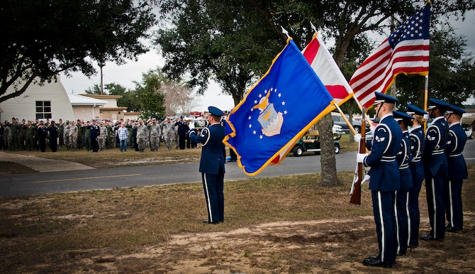 Members of the 919th Special Operations Wing salute their lost Airman during the playing of Taps by Senior Airman Anthony Holochwost, of the Eglin Honor Guard, during the Senior Airman Josh Santos memorial Jan. 13 at Duke Field.  Santos passed away Nov. 26 from colon cancer.  He was a radio operator with the 711th Special Operations Squadron.  During the memorial, it was announced the Duke Field gym would be renamed Santos Strength in his honor.  (U.S. Air Force photo/Tech. Sgt. Samuel King Jr.)