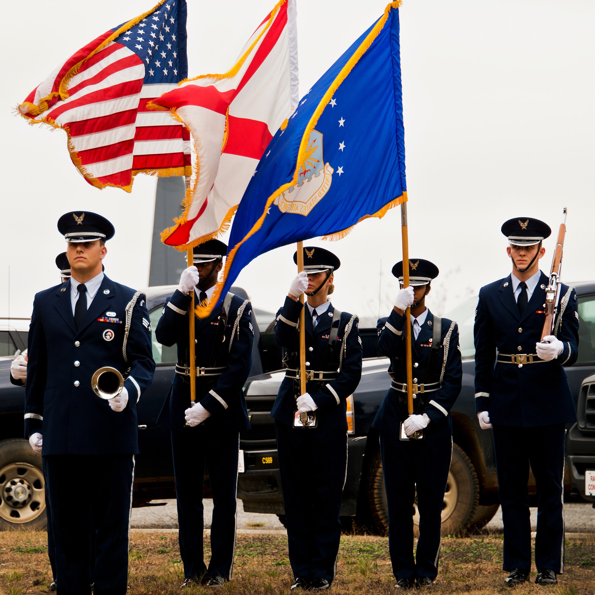Senior Airman Anthony Holochwost and members of the Eglin Honor Guard wait to present the colors and play Taps at the Senior Airman Josh Santos memorial Jan. 13 at Duke Field.  Santos passed away Nov. 26 from colon cancer.  He was a radio operator with the 711th Special Operations Squadron.  During the memorial, it was announced the Duke Field gym would be renamed Santos Strength in his honor.  (U.S. Air Force photo/Tech. Sgt. Samuel King Jr.)