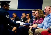 A folded American flag is presented to Senior Airman Josh Santos’ mother, Lisa, during his memorial Jan. 13 at Duke Field, Fla.  Santos passed away Nov. 26 from colon cancer.  He was a radio operator with the 711th Special Operations Squadron.  During the memorial, it was announced the Duke Field gym would be renamed Santos Strength in his honor.   (U.S. Air Force photo/Tech. Sgt. Samuel King Jr.)