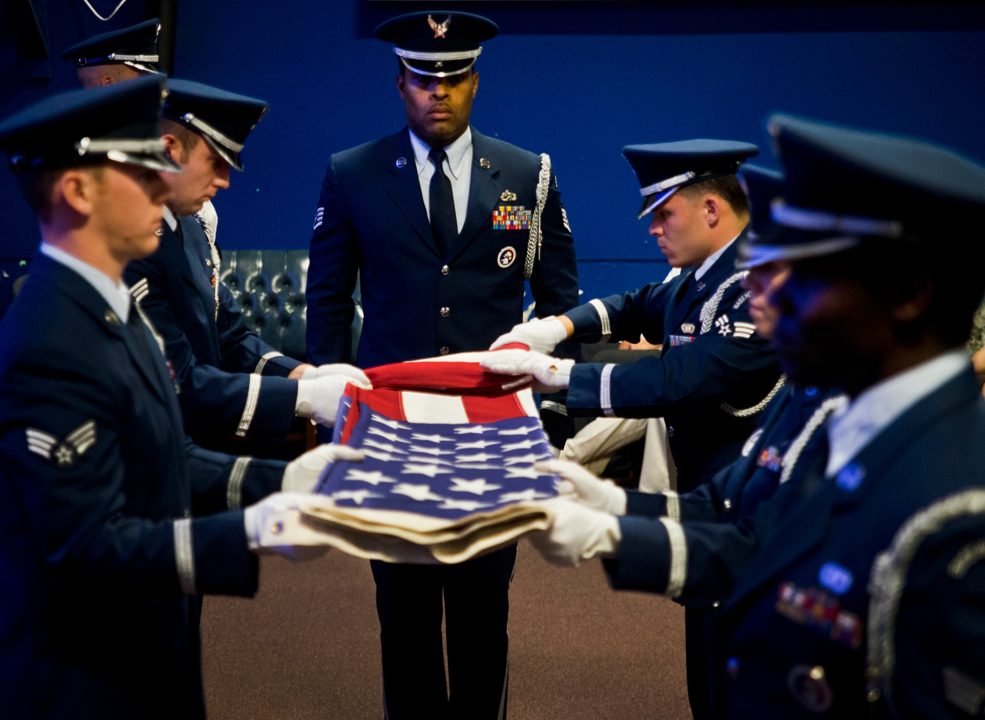 An American flag is folded by the Eglin Honor Guard to be presented to Senior Airman Josh Santos’ mother, Lisa, during his memorial Jan. 13 at Duke Field, Fla.  Santos passed away Nov. 26 from colon cancer.  He was a radio operator with the 711th Special Operations Squadron.  During the memorial, it was announced the Duke Field gym would be renamed Santos Strength in his honor.  (U.S. Air Force photo/Tech. Sgt. Samuel King Jr.)