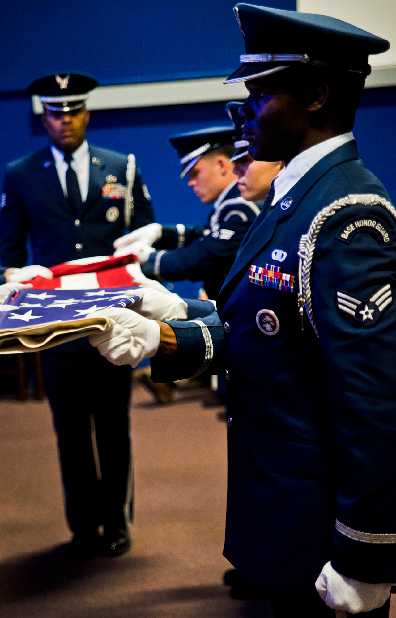 An American flag is folded by the Eglin Honor Guard to be presented to Senior Airman Josh Santos’ mother, Lisa, during his memorial Jan. 13 at Duke Field, Fla.  Santos passed away Nov. 26 from colon cancer.  He was a radio operator with the 711th Special Operations Squadron.  During the memorial, it was announced the Duke Field gym would be renamed Santos Strength in his honor.  (U.S. Air Force photo/Tech. Sgt. Samuel King Jr.)