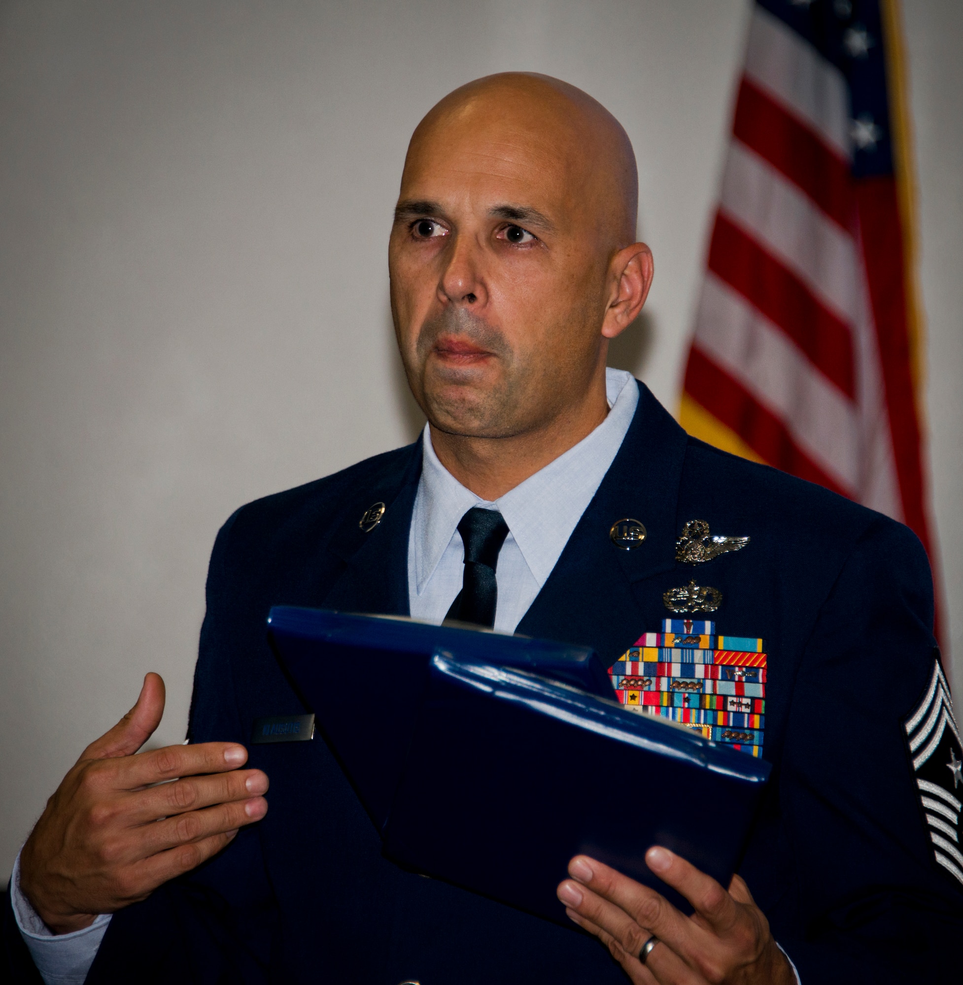 Chief Master Sgt. Michael Klausutis, the 919th Special Operations Wing command chief, fights back emotion while talking about Senior Airman Josh Santos at a memorial held for him Jan. 13 at Duke Field, Fla.  Santos passed away Nov. 26 from colon cancer.  He was a radio operator with the 711th Special Operations Squadron.  During the memorial, it was announced the Duke Field gym would be renamed Santos Strength in his honor.  (U.S. Air Force photo/Tech. Sgt. Samuel King Jr.)